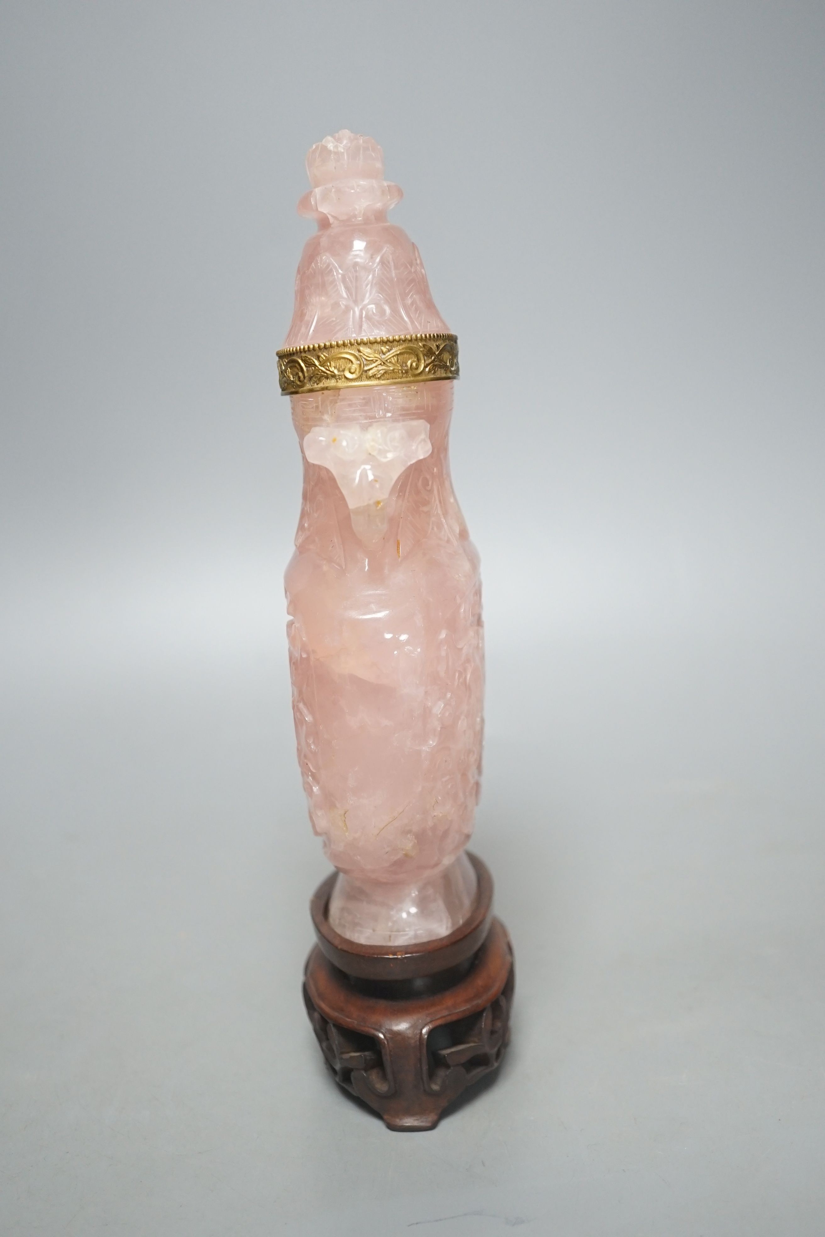 A late 19th/early 20th century Chinese carved rose quartz vase and cover, on a Hongmu stand, 23.5 cm high including stand.